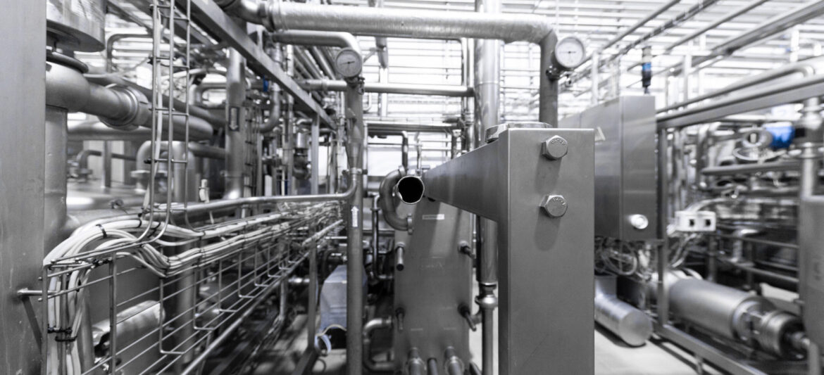 Modern brewery factory interior. pipe lines and other equipment tool in plant workshop. Industrial background. Metal pipes close-up. Industrial plant inside view. Maze of pipes background